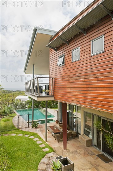 Exterior of house with porch and swimming pool