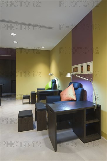 Angle-poise lamps and armchairs in spa lobby