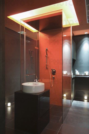 Interior of lit modern bathroom at spa