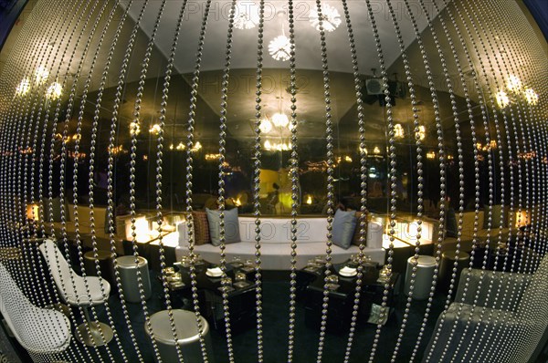 Fisheye view of lounge area behind beaded curtain in nightclub