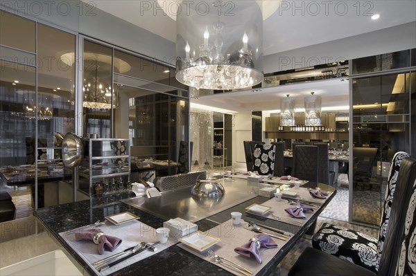 Chandelier above elegant dining table in hotel restaurant