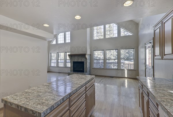 Kitchen island and fireplace in unfurnished house