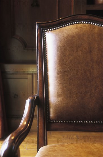 Brown leather and wood armchair