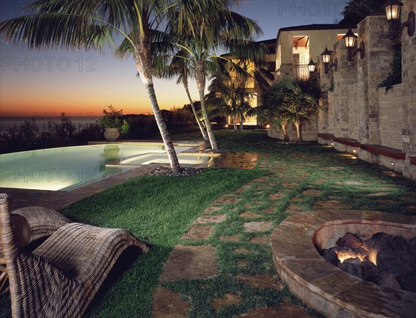 Backyard of modern home with pool at sunset