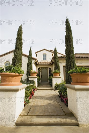 Front sidewalk to home with landscaping