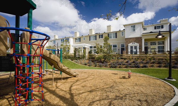 Playground out front of contemporary housing community