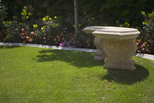 Stone Bench in Yard with Garden