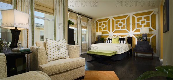 Large Contemporary Master Bedroom with Orange Accents