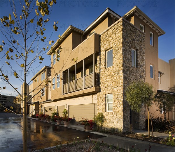 Rear of contemporary townhomes and garages