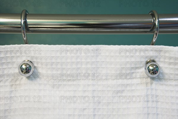 Teal Wall and Curtain Rod Holding White Shower Curtain