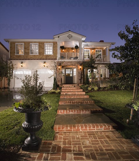 Front exterior multiple story brick shingle style home