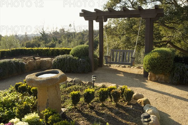 Spanish Style Courtyard with Swing and Bird Bath