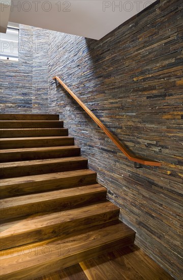 Hardwood Staircase with Stone Tile Wall