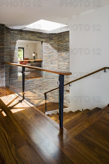 Hardwood Stairwell with Stone Tile Walls