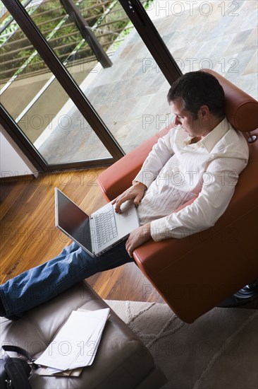 Man Working on Laptop in Modern Living Room