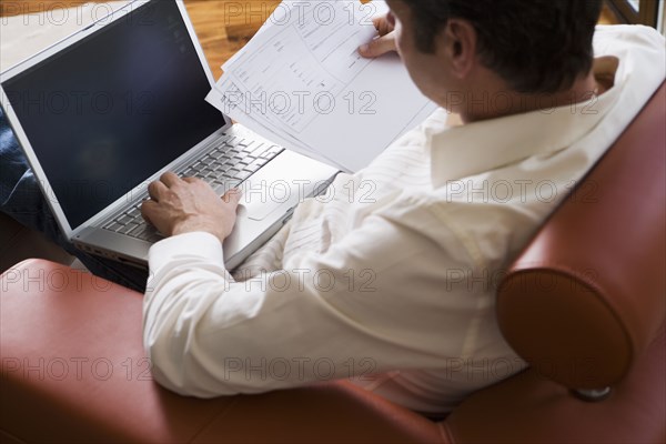 Man Working on Laptop in Modern Living Room