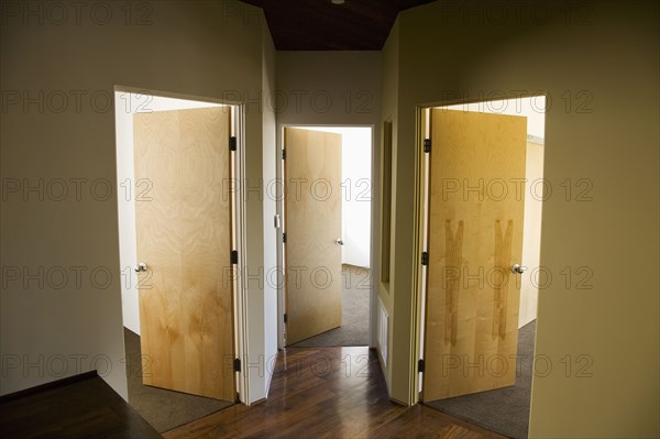 Three Open Doors in Modern Hallway