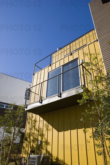 Exterior Detail of Modern Home and Balcony with Yellow Wall