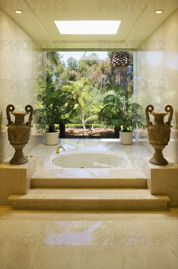 Marble steps leading to an elegant hot tub bathtub