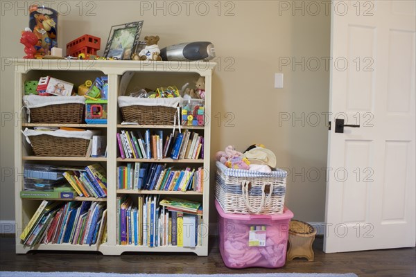 Detail of book shelf with kids toys and books