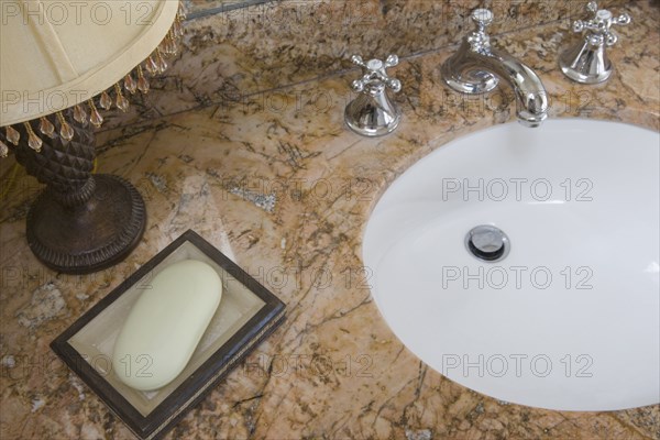 Detail of bathroom sink with chrome faucet and soap dish