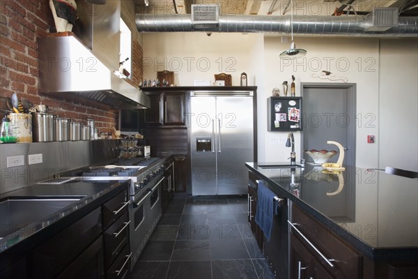 Modern kitchen with stainless steel appliances.