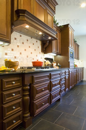 Custom kitchen cabinetry with hood.