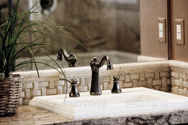 Detail bathroom sink with bronze faucet