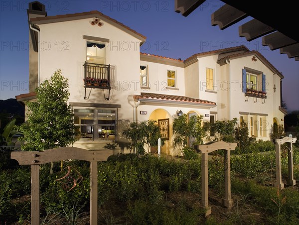 Front exterior Spanish style homes at dusk