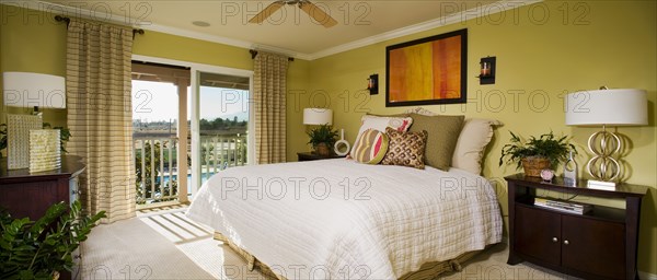 Green master bedroom with sliding glass doors