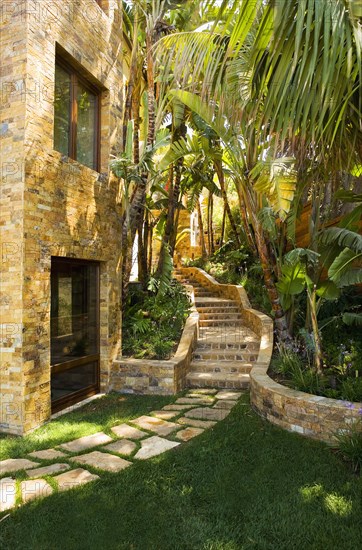 Stone steps leading up to a large tuscan style home