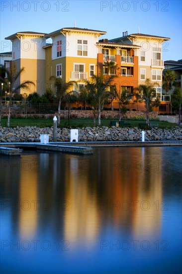 Exterior of residential building with reflection in lake