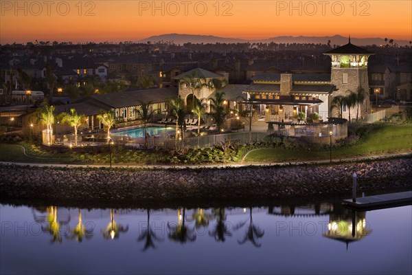 Landscape view of residential buildings with lake in foreground