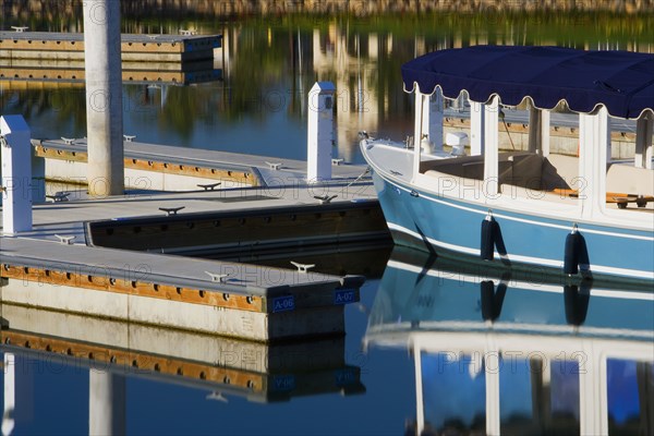 Boats docked at housing community near channel to ocean