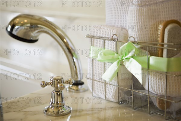 Basket of bath accessories next to tub