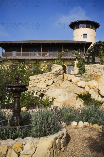 Stone steps leading up to a large spanish style home