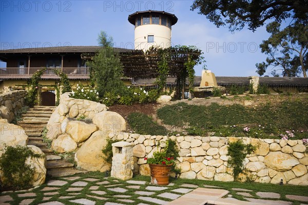 Stone steps leading up to a large spanish style home