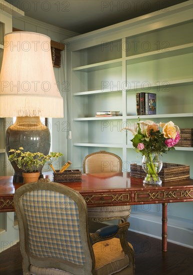 Small desk with chair and a large table lamp