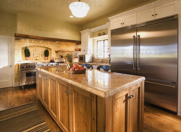 Interior of Kitchen with Island and large stainless steel refrigerator