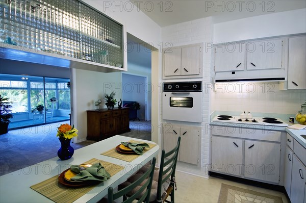 Place settings at breakfast bar in retro kitchen