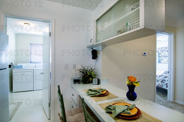 Place settings at breakfast bar outside laundry room