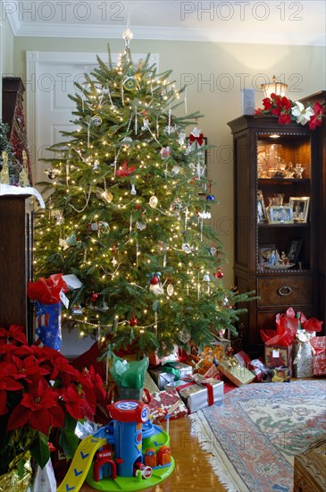 Gift boxes and toys with decorated Christmas tree