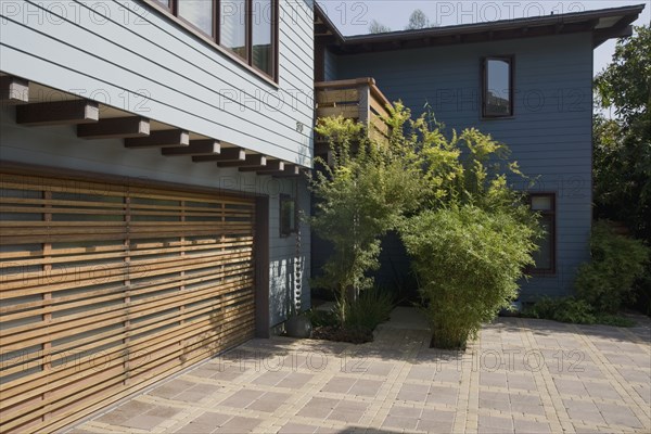 Wooden garage door and blue sided home