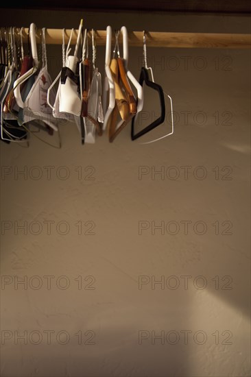 Empty hangers hanging on wooden rod