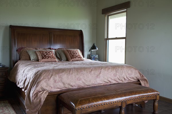 Leather bench at foot of master bed