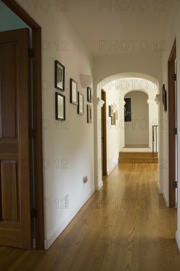 Hallway in traditional home with hardwood floors