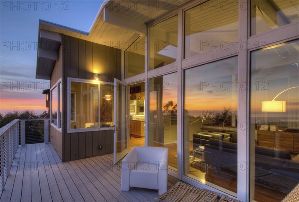 Balcony with glass doors in contemporary house