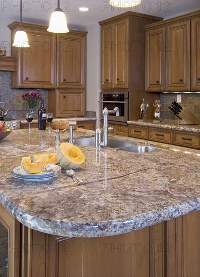 Kitchen with island and marble countertops