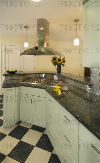 Diner style kitchen with black and white tile floors