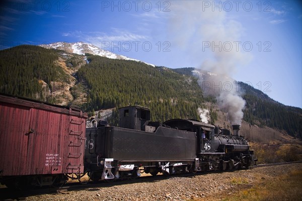 Steam train near mountain